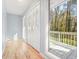 Bright hallway with hardwood floors and a decorative door leading to an outdoor deck at 3310 Bryan Way, Marietta, GA 30008