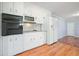 Well-equipped kitchen featuring white cabinets and modern appliances with wood flooring at 3310 Bryan Way, Marietta, GA 30008