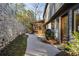 Exterior view of the house with a stone wall, a screened porch, and mature landscaping at 6055 Blackwater Trl, Atlanta, GA 30328