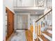 Light and airy foyer featuring hardwood floors, staircase, modern chandelier, and closet with light gray barn doors at 6055 Blackwater Trl, Atlanta, GA 30328