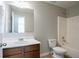 A bathroom featuring a brown vanity, toilet, and bathtub-shower combo at 7416 Toccoa Cir, Union City, GA 30291