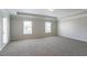 Spacious bedroom featuring tray ceiling detail, recessed lighting, carpet flooring, and natural light at 7416 Toccoa Cir, Union City, GA 30291