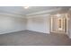 Bright living room featuring neutral walls, plush carpet, and elegant trim work at 7416 Toccoa Cir, Union City, GA 30291