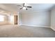 Spacious living area with plush carpet, a ceiling fan, crown molding, and seamless access to adjacent rooms at 7416 Toccoa Cir, Union City, GA 30291