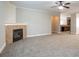 Comfortable living room with a neutral color scheme, plush carpet, and a corner fireplace feature at 7416 Toccoa Cir, Union City, GA 30291