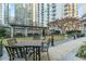 Beautiful outdoor courtyard with seating, a manicured lawn, and a backdrop of high-rise buildings at 199 14Th Ne St # 2312, Atlanta, GA 30309