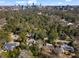 Scenic aerial view of a leafy neighborhood with mature trees and a skyline of the city in the distance at 3330 Habersham Rd, Atlanta, GA 30305