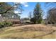 Expansive backyard with manicured lawn, pergola, and charming shed surrounded by mature trees offering shade and privacy at 3330 Habersham Rd, Atlanta, GA 30305