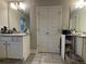 Dual vanities with granite countertops separated by a set of closet doors at 338 Cherryhill Ln, Woodstock, GA 30188