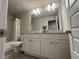 Bathroom with white vanity, granite counters, and shower/tub combo at 338 Cherryhill Ln, Woodstock, GA 30188