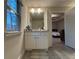 Bright bathroom features a single sink vanity with granite countertop and gray tile flooring at 338 Cherryhill Ln, Woodstock, GA 30188