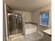 Bathroom with tiled shower, soaking tub, and granite counters at 338 Cherryhill Ln, Woodstock, GA 30188