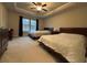 Bedroom featuring two beds, tray ceiling, and a ceiling fan at 338 Cherryhill Ln, Woodstock, GA 30188