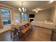 Inviting dining area with a wooden table and benches, connecting to the living room and backyard at 338 Cherryhill Ln, Woodstock, GA 30188