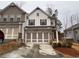 Charming two-story townhome with brick accents and a two-car garage in a well-kept community at 338 Cherryhill Ln, Woodstock, GA 30188