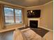 Comfortable living room featuring a fireplace, large window, and plush seating at 338 Cherryhill Ln, Woodstock, GA 30188