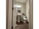 Compact powder room with pedestal sink and wood flooring at 338 Cherryhill Ln, Woodstock, GA 30188