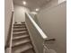 Carpeted staircase with white trim and a wooden handrail leading to the upper level of the home at 338 Cherryhill Ln, Woodstock, GA 30188