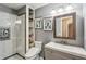Bathroom with a gray vanity, built in storage, tile shower, and neutral colored walls at 8 Colonial Club Se Dr, Acworth, GA 30102
