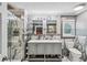 Elegant bathroom featuring double vanity, marble walls, and glass enclosed shower at 8 Colonial Club Se Dr, Acworth, GA 30102