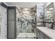 Updated bathroom featuring a glass shower, marble wall, and gray cabinets at 8 Colonial Club Se Dr, Acworth, GA 30102