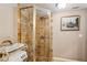 Charming bathroom featuring tiled shower with glass door and seat, complemented by a decorative painting at 8 Colonial Club Se Dr, Acworth, GA 30102