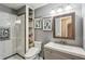 Bathroom with a tiled shower, toilet, and a grey vanity with shelving at 8 Colonial Club Se Dr, Acworth, GA 30102