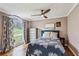 Cozy bedroom with hardwood floors, a window view, and a patterned comforter at 8 Colonial Club Se Dr, Acworth, GA 30102