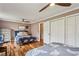 Cozy bedroom featuring hardwood floors, dual beds, ample closet space, and two ceiling fans for comfortable living at 8 Colonial Club Se Dr, Acworth, GA 30102