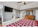 Comfortable bedroom with wood flooring, ceiling fan, television, and access to the bathroom at 8 Colonial Club Se Dr, Acworth, GA 30102