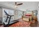 Spacious bedroom with hardwood floors, ceiling fans, treadmill and natural light from many windows at 8 Colonial Club Se Dr, Acworth, GA 30102