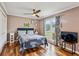 Cozy bedroom with hardwood floors, a ceiling fan, and a large window offering natural light at 8 Colonial Club Se Dr, Acworth, GA 30102