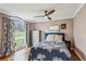 Bright bedroom with hardwood floors, large window, charming blue bedframe and neutral-toned walls at 8 Colonial Club Se Dr, Acworth, GA 30102