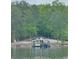 Scenic view of a boat dock with a boat slip on a tranquil lake surrounded by lush trees at 8 Colonial Club Se Dr, Acworth, GA 30102