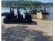 Utility vehicle by the lake with boat dock at 8 Colonial Club Se Dr, Acworth, GA 30102