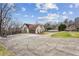 Wide driveway leading to a well-maintained home with a basketball hoop and lush landscaping at 8 Colonial Club Se Dr, Acworth, GA 30102