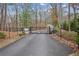 Gated entrance to the community with mature trees and well-maintained landscaping at 8 Colonial Club Se Dr, Acworth, GA 30102