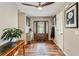 Stylish entryway featuring hardwood floors and a modern ceiling fan, adjacent to a white-painted door at 8 Colonial Club Se Dr, Acworth, GA 30102