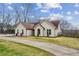 Side view of home with a basketball court and well-kept yard with a long driveway at 8 Colonial Club Se Dr, Acworth, GA 30102