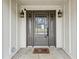 Welcoming front entrance with decorative lights, a glass door, and a 'Home Sweet Home' welcome mat at 8 Colonial Club Se Dr, Acworth, GA 30102