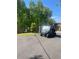 Utility vehicle parked on the driveway by a large, landscaped front yard with a for-sale sign at 8 Colonial Club Se Dr, Acworth, GA 30102
