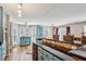 Bright kitchen with an island bar, modern appliances, wooden floors, and plentiful sunlight at 8 Colonial Club Se Dr, Acworth, GA 30102