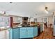 Open kitchen featuring a breakfast bar island with sink, stone countertops, and stainless steel appliances at 8 Colonial Club Se Dr, Acworth, GA 30102