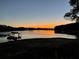 Picturesque waterfront view of a dock on calm lake at dusk in a lovely lakeside community at 8 Colonial Club Se Dr, Acworth, GA 30102