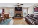 Cozy living room with a brick fireplace, large windows, and comfortable seating area at 8 Colonial Club Se Dr, Acworth, GA 30102