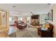 Spacious living room featuring wood-burning fireplace, leather furniture, and wood flooring at 8 Colonial Club Se Dr, Acworth, GA 30102