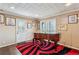 Bright living room features a classic piano and an area rug with bold, contrasting colors at 8 Colonial Club Se Dr, Acworth, GA 30102