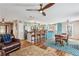 Spacious living space with a kitchen island, hardwood floors, and natural light from large windows at 8 Colonial Club Se Dr, Acworth, GA 30102