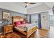 Main bedroom featuring a tray ceiling, hardwood floors, and large windows at 8 Colonial Club Se Dr, Acworth, GA 30102