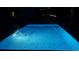 A backyard rectangular pool shines at night, promising refreshing swims and relaxation at 8 Colonial Club Se Dr, Acworth, GA 30102